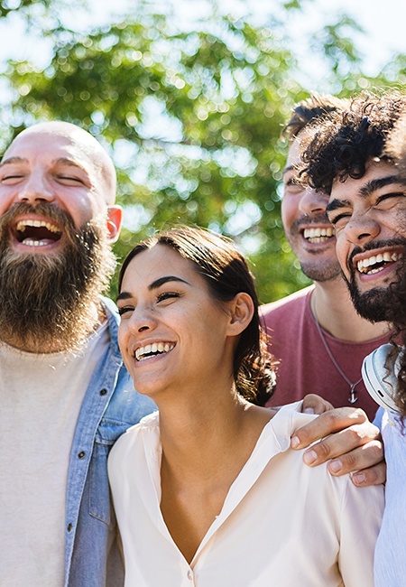 Patient in Lutz with veneers smiling with friends